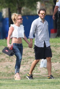 Britney Spears shows off her abs in a white crop top and blue jeans